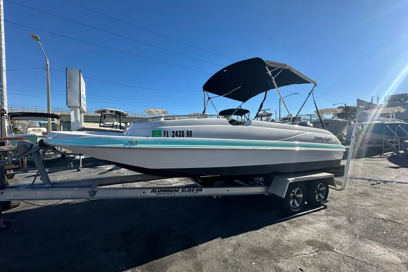 Slide: The Image of 2018 Starcraft Limited 2000 OB Fish boat on trailer, sunny day, outdoor display. - 0