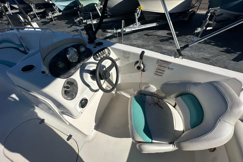Slide: The Image of 2018 Starcraft Limited 2000 OB Fish boat interior with steering wheel and seating. - 10