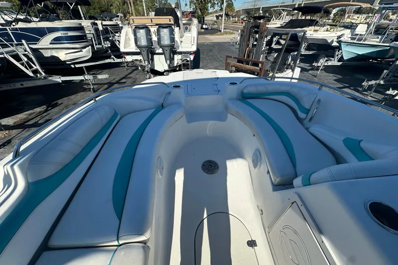 Slide: The Image of 2018 Starcraft Limited 2000 OB Fish boat interior with teal accents, docked among other boats. - 11