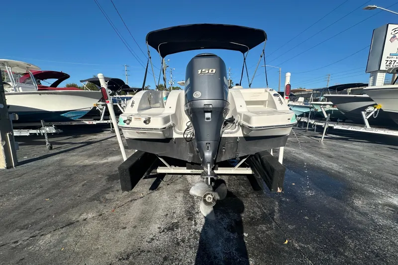 Slide: The Image of 2018 Starcraft Limited 2000 OB Fish boat with outboard motor, displayed in a marina. - 4