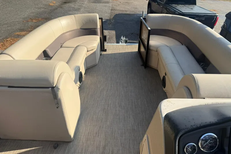Slide: The Image of 2023 Bentley Pontoons 240 Navigator interior with beige seating and dashboard. - 3
