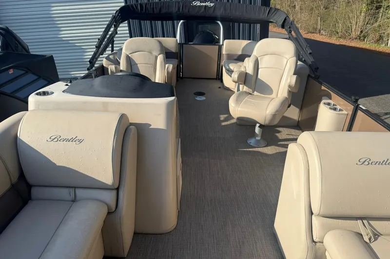 Slide: The Image of 2023 Bentley Pontoons 240 Navigator interior with beige seating and helm station. - 4