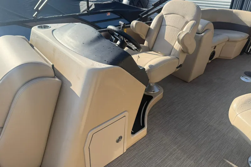 Slide: The Image of 2023 Bentley Pontoons 240 Navigator interior with beige seating and steering console. - 5