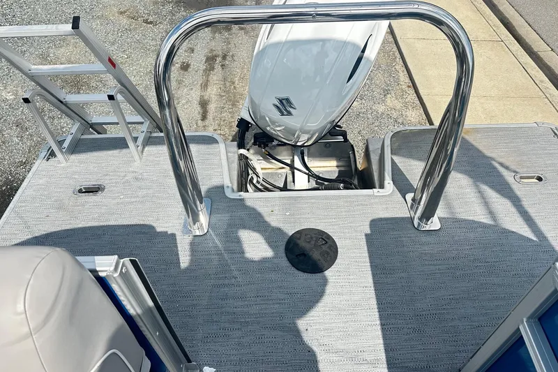 Slide: The Image of 2026 Godfrey EX 2286 SBX boat deck with motor and ladder. - 10