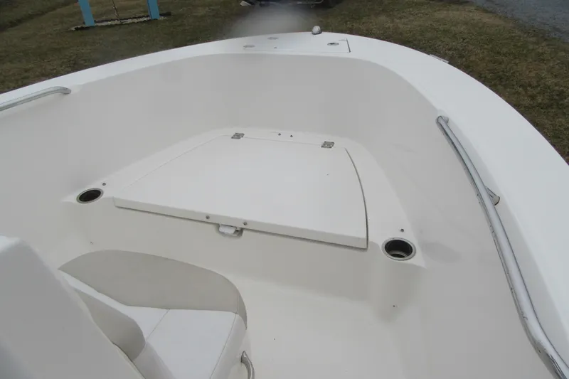 Slide: The Image of 2015 Robalo R180 Center Console boat interior with seating and storage. - 10