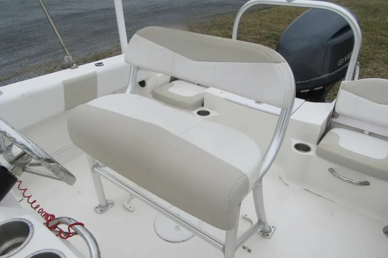 Slide: The Image of 2015 Robalo R180 Center Console boat interior with seating and Yamaha engine. - 17