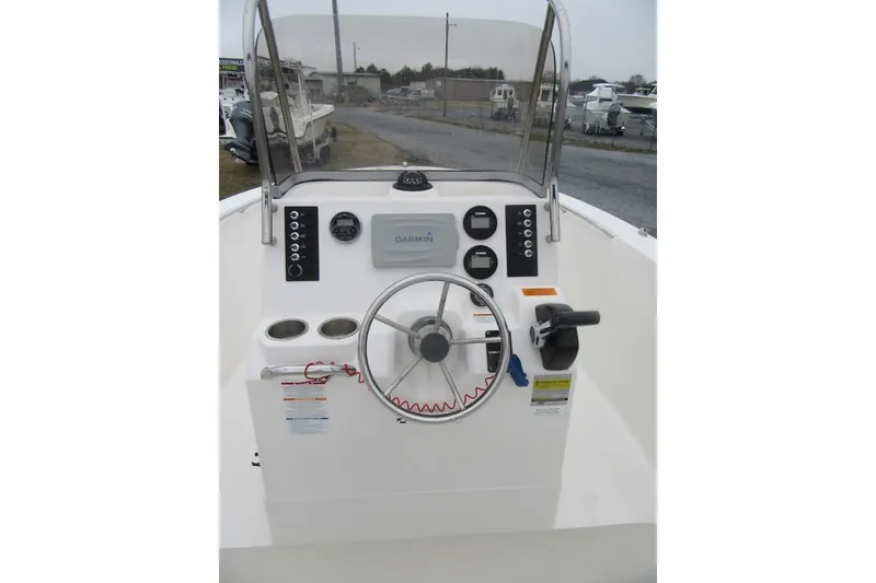 Slide: The Image of 2015 Robalo R180 Center Console boat dashboard with steering wheel and Garmin display. - 18