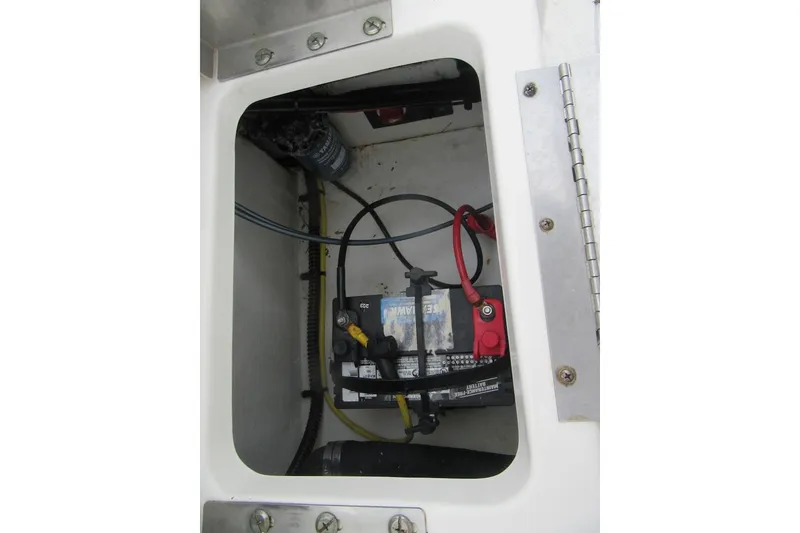 Slide: The Image of 2015 Robalo R180 Center Console battery compartment with wiring and components. - 22