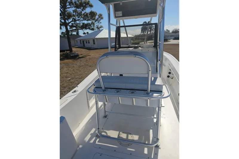 Slide: The Image of 1996 Mako 231 Center Console boat interior with seating and rod holders. - 15