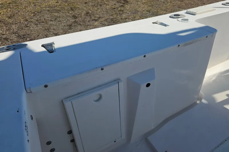 Slide: The Image of 1996 Mako 231 Center Console boat interior detail with storage compartment. - 17