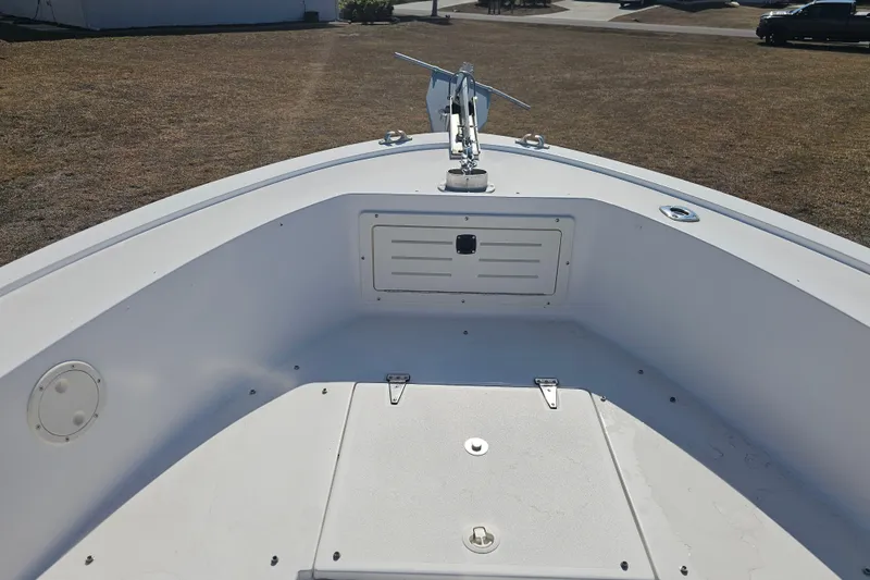 Slide: The Image of 1996 Mako 231 Center Console boat deck with anchor and storage compartments. - 21