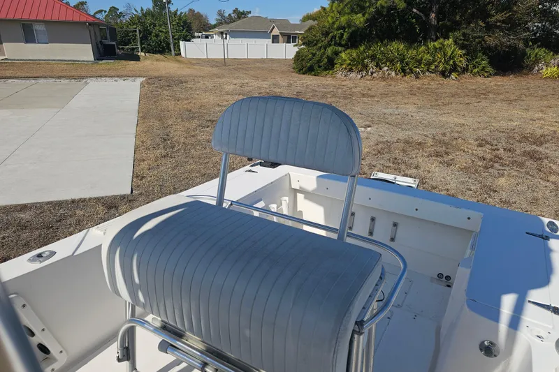 Slide: The Image of 1996 Mako 231 Center Console boat interior with seating, outdoors. - 24