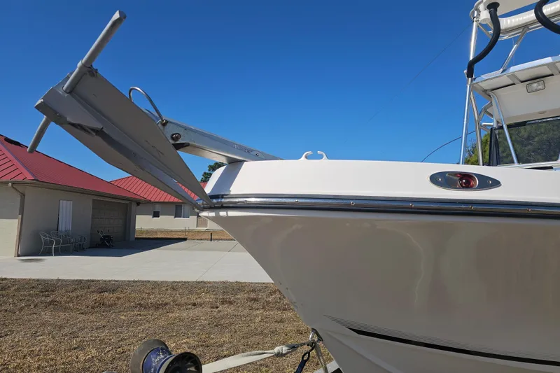 Slide: The Image of 1996 Mako 231 Center Console boat with anchor, parked on dry land. - 3