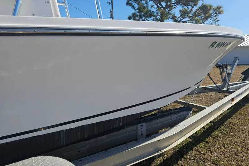 Slide: The Image of 1996 Mako 231 Center Console boat on trailer, side view. - 30