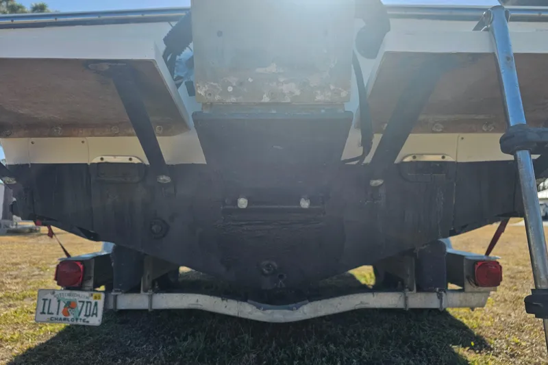Slide: The Image of Rear view of a 1996 Mako 231 Center Console boat on a trailer. - 32