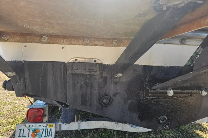 Slide: The Image of 1996 Mako 231 Center Console boat hull with Florida license plate on trailer. - 33