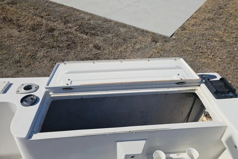 Slide: The Image of Open storage compartment on a 1996 Mako 231 Center Console boat. - 35