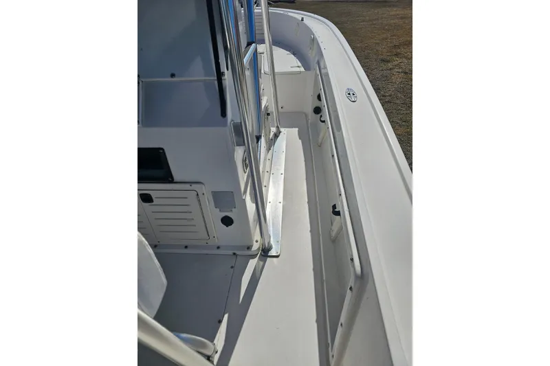 Slide: The Image of 1996 Mako 231 Center Console boat interior, featuring clean white deck and console. - 36