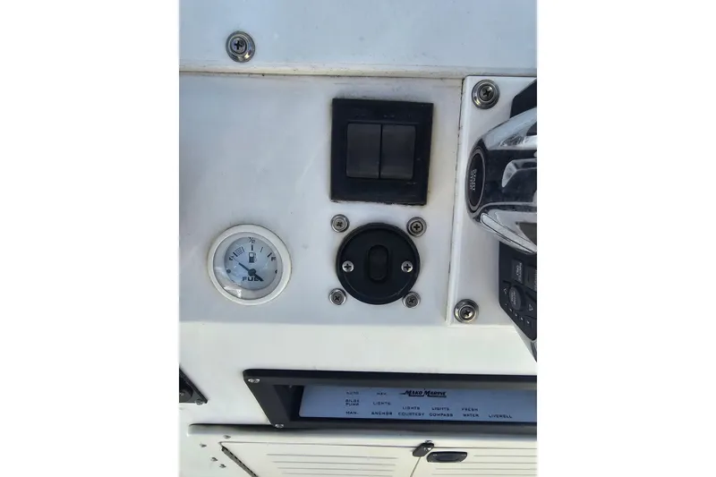 Slide: The Image of 1996 Mako 231 Center Console dashboard with fuel gauge and controls. - 38