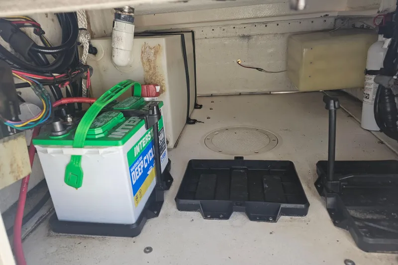 Slide: The Image of 1996 Mako 231 Center Console boat interior with marine battery and wiring. - 39