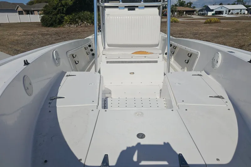Slide: The Image of 1996 Mako 231 Center Console boat interior with seating and storage compartments. - 4