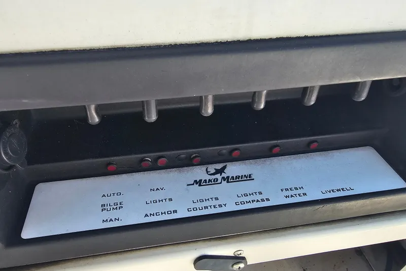 Slide: The Image of Control panel of a 1996 Mako 231 Center Console boat with labeled switches. - 41