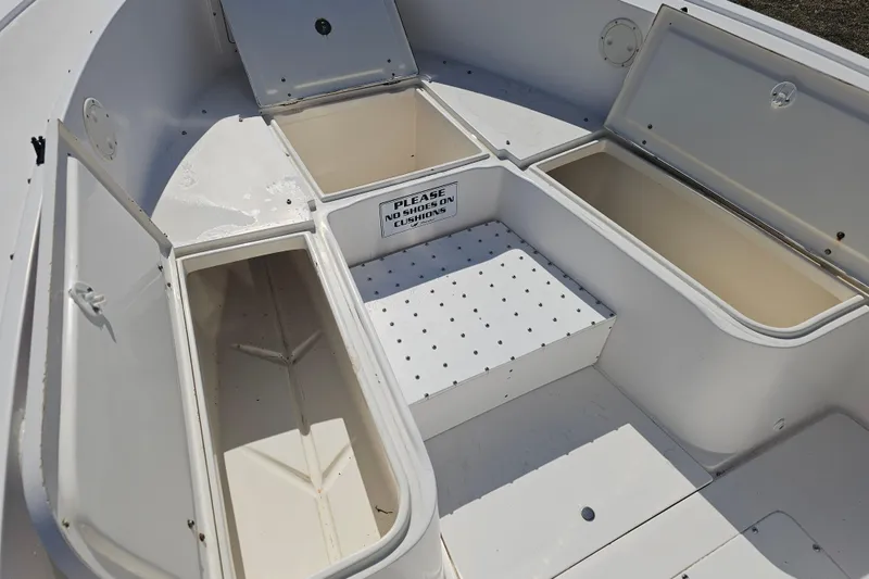 Slide: The Image of Open storage compartments on a 1996 Mako 231 Center Console boat. - 43