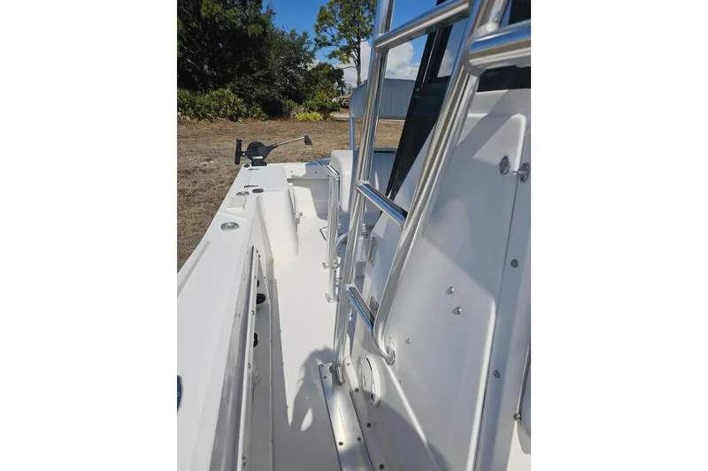 Slide: The Image of 1996 Mako 231 Center Console boat with stainless steel railings and open deck. - 44