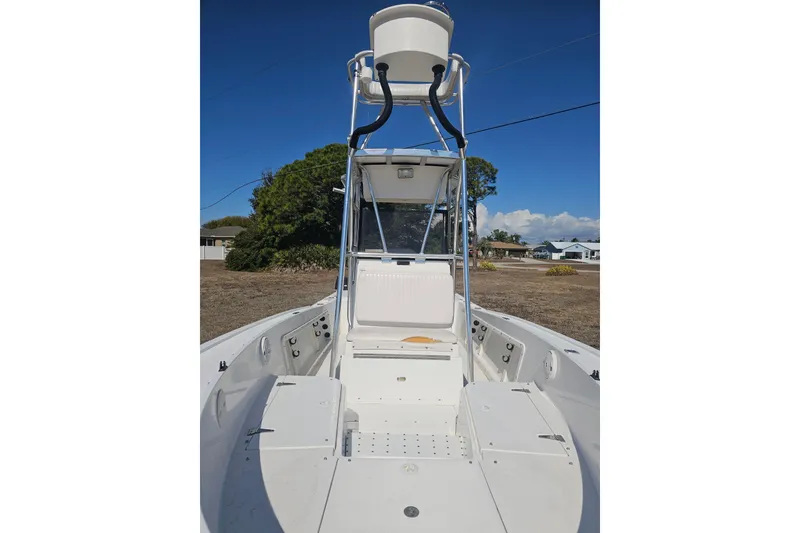 Slide: The Image of 1996 Mako 231 Center Console boat with elevated helm, parked on dry land. - 46