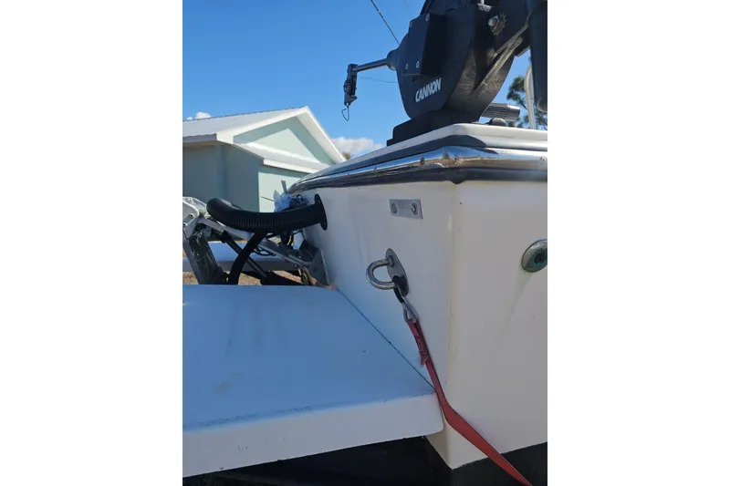 Slide: The Image of 1996 Mako 231 Center Console boat detail with Cannon equipment, blue sky background. - 48