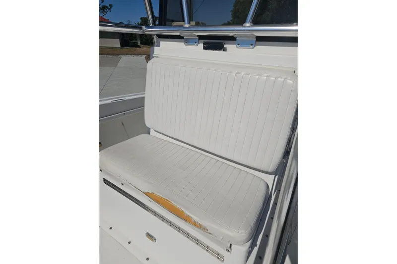 Slide: The Image of 1996 Mako 231 Center Console boat seat with visible wear and tear. - 52