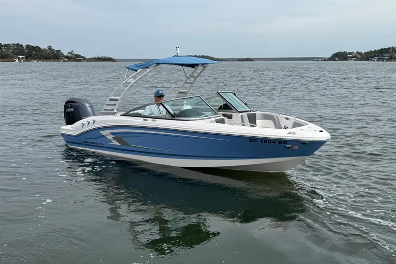 Slide: The Image of 2024 Chaparral 21 SSi OB boat on water, featuring sleek blue and white design. - 1