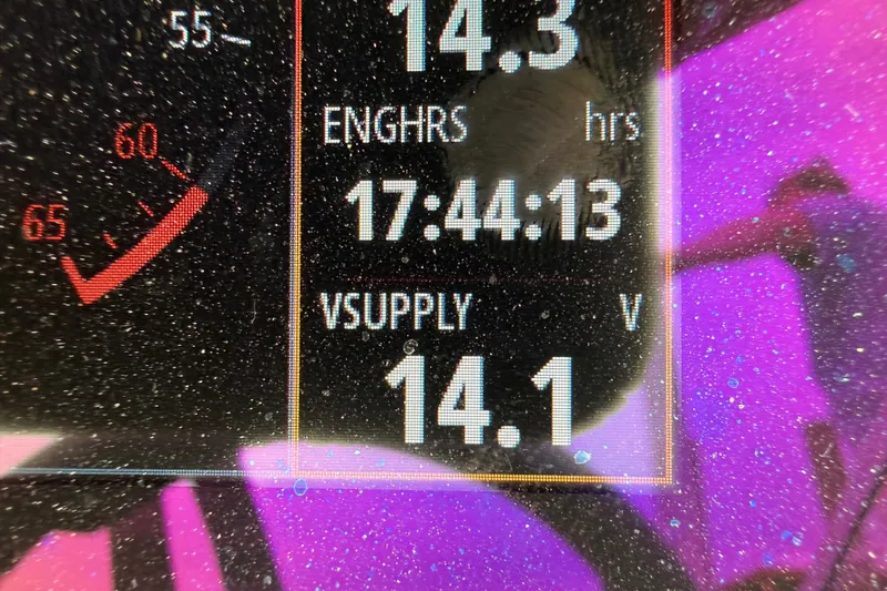 Slide: The Image of Dashboard display of 2024 Chaparral 21 SSi OB showing engine hours and voltage supply. - 12