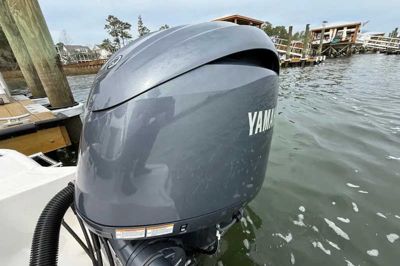 Slide: The Image of 2024 Chaparral 21 SSi OB with Yamaha outboard engine on a calm waterfront. - 7