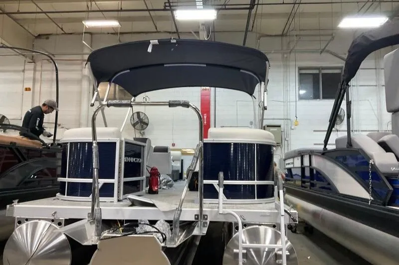 Slide: The Image of 2026 Bennington 22 SSRSF pontoon boat in a showroom with canopy and modern design. - 17