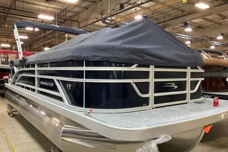 Slide: The Image of 2026 Bennington 22 SSRSF pontoon boat covered in a warehouse setting. - 20