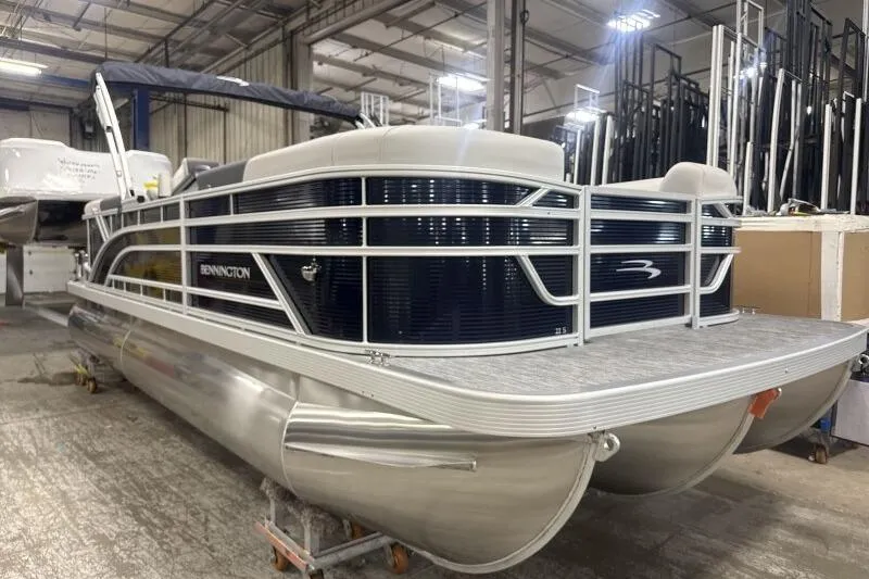 Slide: The Image of 2026 Bennington 22 SSRSF pontoon boat in a warehouse setting. - 4