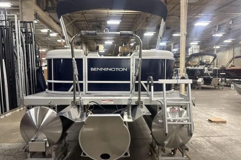 Slide: The Image of 2026 Bennington 22 SSRSF pontoon boat in a factory setting, rear view. - 6
