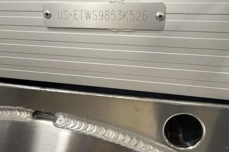 Slide: The Image of 2026 Bennington 22 SSRSF boat hull identification number plate with visible weld detail. - 7
