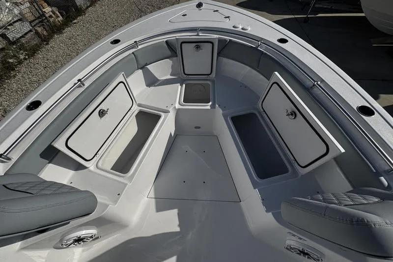 Slide: The Image of 2026 Sportsman Heritage 261 Center Console boat interior with open storage compartments. - 12