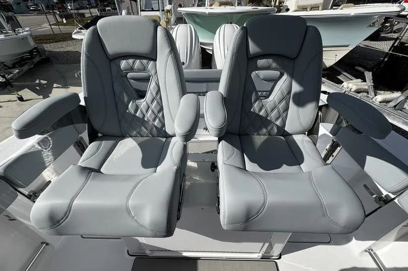 Slide: The Image of 2026 Sportsman Heritage 261 Center Console boat seats, featuring luxurious gray upholstery. - 24