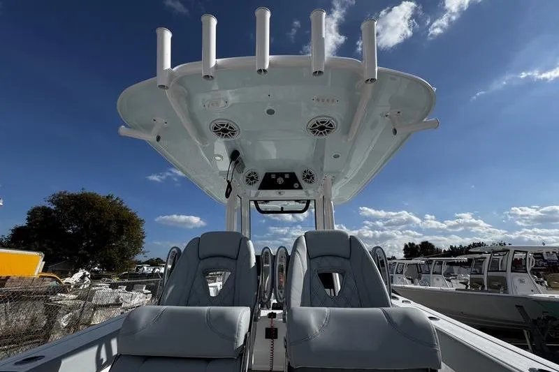 Slide: The Image of 2026 Sportsman Heritage 261 Center Console boat interior with seating and rod holders. - 26