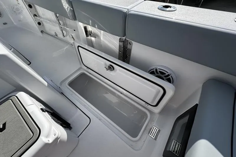 Slide: The Image of 2026 Sportsman Heritage 261 Center Console boat interior with open storage compartment. - 28