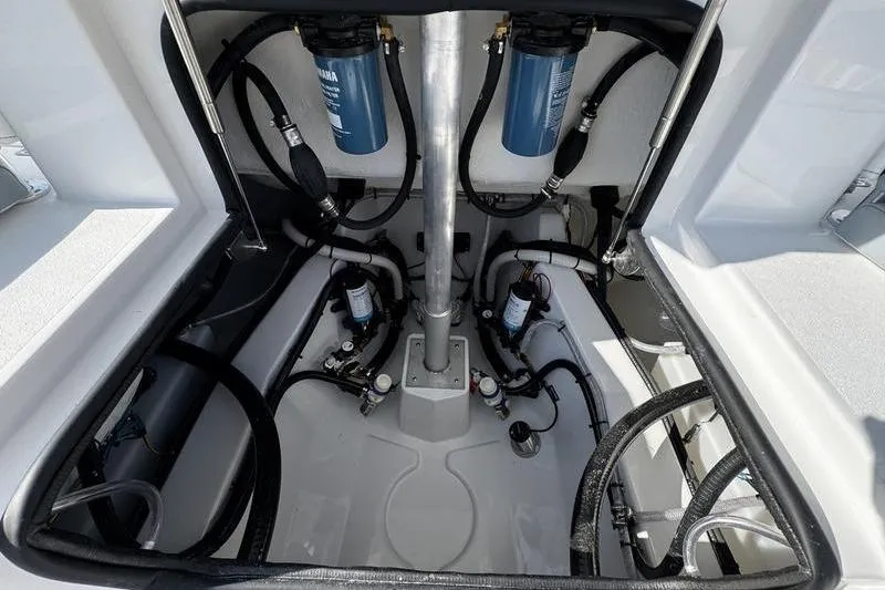 Slide: The Image of 2026 Sportsman Heritage 261 Center Console boat interior with visible wiring and components. - 30
