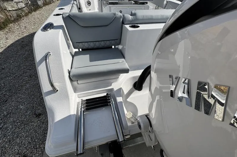 Slide: The Image of 2026 Sportsman Heritage 261 Center Console boat with Yamaha engine and seating area. - 33