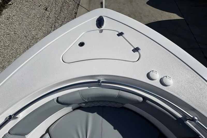 Slide: The Image of 2026 Sportsman Heritage 261 Center Console boat bow with seating and storage compartments. - 6