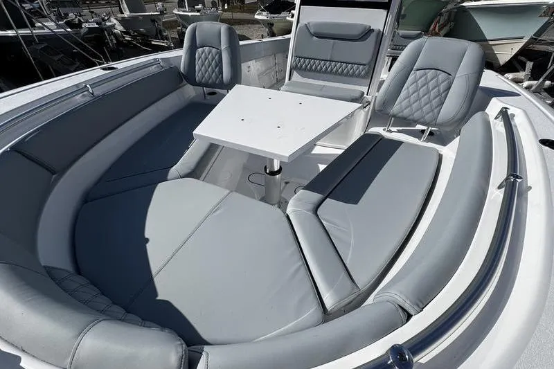 Slide: The Image of 2026 Sportsman Heritage 261 Center Console boat with luxurious seating and table setup. - 9
