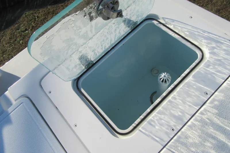 Slide: The Image of Open hatch on 2024 Parker 2320 SL Sport Cabin boat, showing interior compartment. - 12
