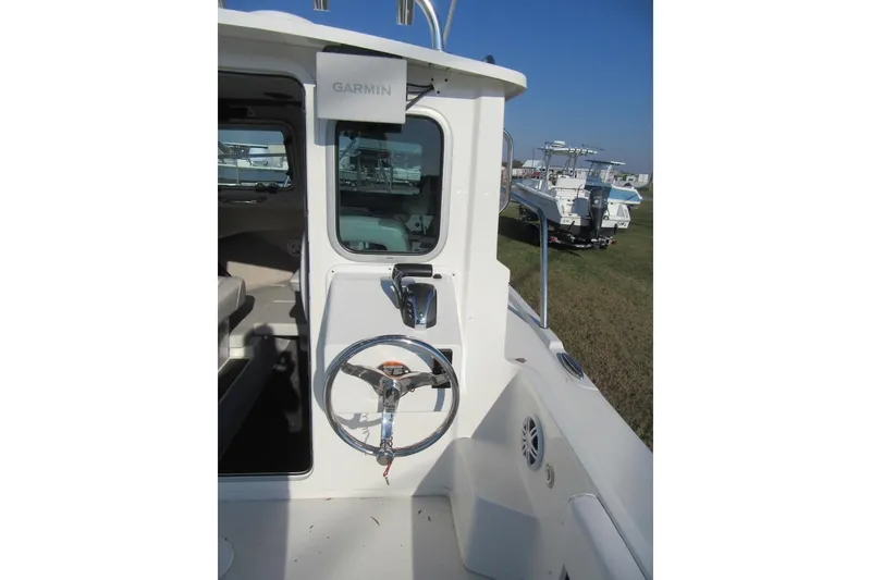 Slide: The Image of 2024 Parker 2320 SL Sport Cabin boat helm with Garmin navigation system. - 19