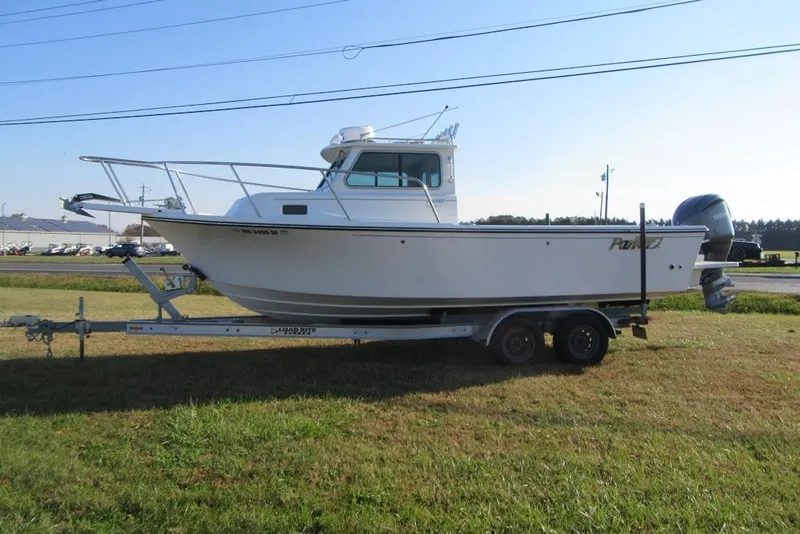 The Image of 2024 Parker 2320 SL Sport Cabin boat on trailer, side view. - 2